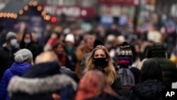 Shoppers do their last Christmas shopping in Leicester Square in London, Wednesday, Dec. 22, 2021.