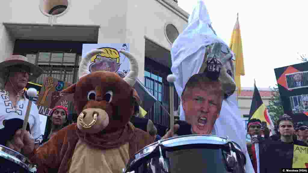 Native Americans protesting a scheduled campaign-style rally by President Donald Trump in Phoenix play drums and burn sage as part of massive anti Trump protest, in Phoenix, Aug. 22, 2017.