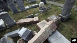President Donald Trump holds up a newspaper with the headline that reads "Trump acquitted" during the 68th annual National Prayer Breakfast, at the Washington Hilton in Washington, D.C.