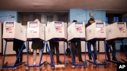Voters fill out their forms at a polling station in the Brooklyn borough of New York, Nov. 8, 2016.