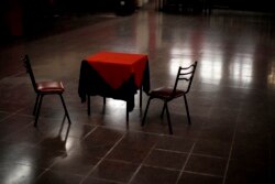 A table and chairs sit amid the empty dance floor of La Viruta Tango club, closed during the COVID-19 pandemic lockdown in Buenos Aires, Argentina, Friday, June 4, 2021.