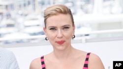 FILE - Scarlett Johansson poses for photographers at the 76th Cannes Film Festival, in southern France, May 24, 2023. OpenAI halted the use of one of its ChatGPT voices after some drew similarities to Johansson in the film “Her.” (Photo by Joel C Ryan/Invision/AP, File)
