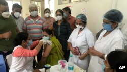 A health worker administers a dose of the Covishied vaccine for COVID-19 at Railway hospital in Prayagraj, India. Saturday, June 26, 2021. (AP Photo/Rajesh Kumar Singh)