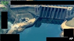 FILE - This photo released on March 27, 2017 by the official Twitter account of Operation Inherent Resolve, shows the Tabqa Dam, in Raqqa, Syria.