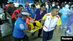 Rescuers carry an injured person on a stretcher after a boat capsized off the tourist island of Phuket, Thailand, July 5, 2018.