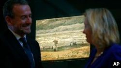 Van Gogh Museum director Axel Rueger, left, and Jet Bussemaker, Minister for Education, Culture and Science, stand next to the stolen and recovered "Seascape at Scheveningen" by Dutch master Vincent van Gogh, during a press conference in Amsterdam, Netherlands, Tuesday, March 21, 2017. 