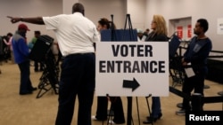 FILE - Voters wait in line to cast their ballots during early voting at the Franklin County Board of Elections in Columbus, in Columbus, Ohio.
