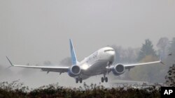 A United Airlines Boeing 737 Max airplane takes off in the rain, Dec. 11, 2019, at Renton Municipal Airport in Renton, Wash.