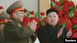 A boy is silhouetted as he jumps into the sea at a beach in the city of Durres, some 40 km (25 miles) from Tirana, Albania, Aug. 13, 2013.