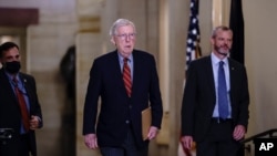 Senate Minority Leader Mitch McConnell, R-Ky., joined by Robert Duncan, the secretary for the minority, walks to the chamber as the Senate works to advance the $1 trillion bipartisan infrastructure bill, at the Capitol in Washington, Aug. 2, 2021