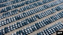 Electric (EVs) and hybrid vehicles wait to be transported in a distribution center of Chinese state-owned automobile manufacturer Changan in southwest China's Chongqing municipality, Jan. 12, 2025.
