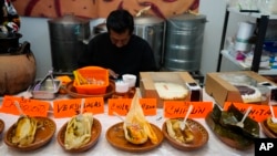 Tamales of different styles are displayed on a table during the tamales fair at the Ixtapalapa neighborhood of Mexico City, Friday, Jan. 27, 2023. (AP Photo/Fernando Llano)