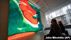 Visitors view artist Refik Anadol's "Unsupervised" exhibit at the Museum of Modern Art, Wednesday, Jan. 11, 2023, in New York. (AP Photo/John Minchillo)