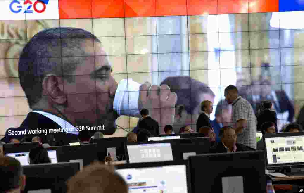 An image of U.S. President Barack Obama drinking out of a paper cup is shown on a large screen in the media center of a G-20 summit in St. Petersburg, Russia, Sept. 6, 2013.&nbsp;