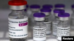 Vials of the AstraZeneca and Pfizer-BioNTech Comirnaty coronavirus disease (COVID-19) vaccines are pictured in a General practitioners practice in Berlin, Germany, April 10, 2021. 