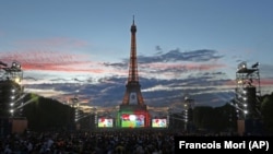 FILE - Fans watch the Euro 2016 final soccer match between Portugal and France in Paris, France, July 10, 2016. (AP Photo/Francois Mori)
