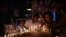 FILE - People hold a candlelight vigil for the victims and injured demonstrators during anti-government protests, in Colombo, July 16, 2022.