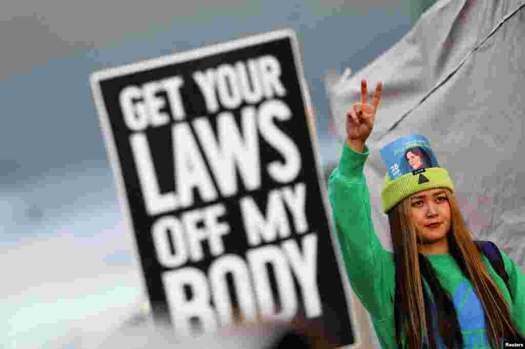 A demonstrator gestures during a protest following the death of Mahsa Amini in Iran, near the Brandenburg Gate, in Berlin, Germany.