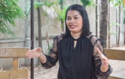 Sorn Sreynuch translates updates about COVID-19 for deaf people from a weekly conference at the Ministry of Health. She has worked as a Cambodian sign language translator for fifteen years. She told VOA Khmer that the work has given her a chance to help empower deaf people in Cambodia. (Hean Socheata/VOA Khmer)