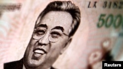 North Korean leader Kim Il-sung is seen on this 5000 North Korea won banknote in this photo illustration taken in Shanghai May 23, 2013.