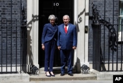 Britain's Prime Minister Theresa May greets Israeli Prime Minister Benjamin Netanyahu in Downing Street, London, June 6, 2018.