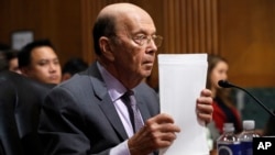 Secretary of Commerce Wilbur Ross straightens his papers during a Senate Finance Committee hearing on tariffs, on Capitol Hill, June 20, 2018 in Washington. 