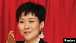 FILE - Li Xiaolin, the daughter of former Chinese Premier Li Peng, attends a news conference. Li is one of the family members of former and current leaders listed in the report.