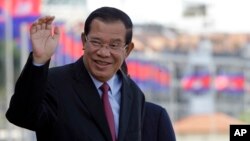 Cambodia's Prime Minister Hun Sen greets his government officials as he arrives to watch the boat races at the Royal Palace during the annual water festival in Phnom Penh, Cambodia, Thursday, Nov. 2, 2017. The 3-day traditional water festival is dedicated