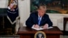 President Donald Trump signs a Presidential Memorandum on the Iran nuclear deal from the Diplomatic Reception Room of the White House, May 8, 2018.