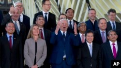 Romanian Foreign Minister Teodor-Viorel Melescanu, center, stands with European Union foreign policy chief Federica Mogherini, second left, and Singapore's Foreign Minister Vivian Balakrishnan, left, during a group photo at an EU ASEAN meeting, Brussels, Monday, Jan. 21, 2019. 