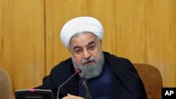 In this photo released by official website of the office of the Iranian presidency, President Hassan Rouhani speaks during a cabinet meeting in Tehran, Iran, July 19, 2017. The U.S. House of Representatives voted overwhelmingly July 25, 2017, in favor of 