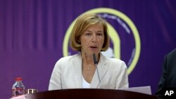 A police officer wearing personal protective equipment carries food and daily supplies that will be distributed to those living in a restricted residential area because of the spread of COVID-19 in Manzhouli in China's northern Inner Mongolia region.