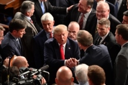 US President Donald Trump is greeted after delivering the State of the Union address at the US Capitol in Washington, DC, on February 4, 2020. (Photo by MANDEL NGAN / AFP)