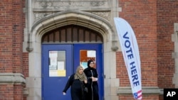 ผู้มีสิทธิเลือกตั้งในสหรัฐฯ เดินออกจากหน่วยเลือกตั้งที่โรงเรียนประถมแมคโดนัลด์ เมืองเดียร์บอร์น รัฐมิชิแกน เมื่อ 5 พ.ย. 2567