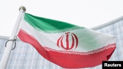 FILE - The flag of Iran waves in front of the the International Center building with the headquarters of the International Atomic Energy Agency, IAEA, in Vienna, May 24, 2021.