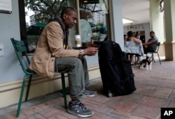 Darnell Metcalf, 55, a regular customer of Starbucks, sits outside of the store after it closed temporarily, May 29, 2018, in Miami.