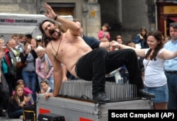 Magician Timothy Terror gets off a bed of nails as he performs on the first day of the Edinburgh Fringe Festival, Aug 2010. (AP /Scott Campbell)