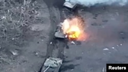 Smoke and fire rise from Russian vehicle during fighting near Synkivka