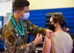 FILE - Hickam 15th Medical Group host the first COVID-19 mass vaccination on Joint Base Pearl Harbor-Hickam, in this Feb. 9, 2021, photo provided by the Department of Defense.