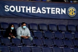 Fans wear masks and sit in marked-off seats at an NCAA college basketball game in the Southeastern Conference tournament Wednesday, March 10, 2021, in Nashville, Tenn.