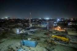Construction work on a highway flyover in a portion cleared of graves in the City of Dead in Cairo, Egypt, Sunday, July 26, 2020. The overpass cuts through the Southern Cemetery.