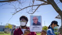 An African-American holding a portrait picture of Vicha Ratanapakdee during the Asian American event to raise awareness about the increase in hate crimes against Asians in the US near Chinatown Los Angeles, CA.