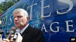 Evangelist Franklin Graham speaks to media in front of his bus after a mass prayer rally on Boston Common, Tuesday, Aug. 30, 2016, in Boston, Massachusetts. (AP Photo/Elise Amendola)