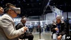 Attendees try the new Oculus Go goggles during F8, Facebook's developer conference, Tuesday, May 1, 2018, in San Jose, Calif. (AP Photo/Marcio Jose Sanchez)