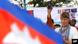 U.N. Special Rapporteur on Human Rights in Cambodia, Rhona Smith, delivers a speech to mark May Day at Tonle Sap river bank in Phnom Penh, Cambodia, Wednesday, May 1, 2019. Some hundreds of workers staged a rally, demanding a better working condition. (AP
