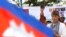 U.N. Special Rapporteur on Human Rights in Cambodia, Rhona Smith, delivers a speech to mark May Day at Tonle Sap river bank in Phnom Penh, Cambodia, Wednesday, May 1, 2019. Some hundreds of workers staged a rally, demanding a better working condition. (AP
