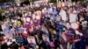 Supporters of various political parties hold placards as constituency candidates arrive for their registration for the upcoming general election, at the Thailand-Japan Youth Center stadium in Bangkok, Thailand, April 3, 2023. 