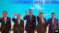 U.S. President Barack Obama, center, waves with leaders of the Association of Southeast Asian Nations (ASEAN) during ASEAN-U.S. summit, a parallel summit in the ongoing 28th and 29th ASEAN Summits and other related summits at National Convention Center i