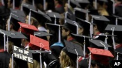 In this Saturday, Aug. 6, 2011 file picture, students attend graduation ceremonies at the University of Alabama in Tuscaloosa, Ala. (AP Photo/Butch Dill)