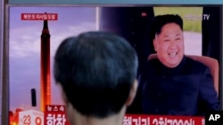 FILE - A man watches a TV screen showing file footage of North Korea's missile launch and North Korean leader Kim Jong Un, at the Seoul Railway Station in Seoul, South Korea, Sept. 15, 2017.